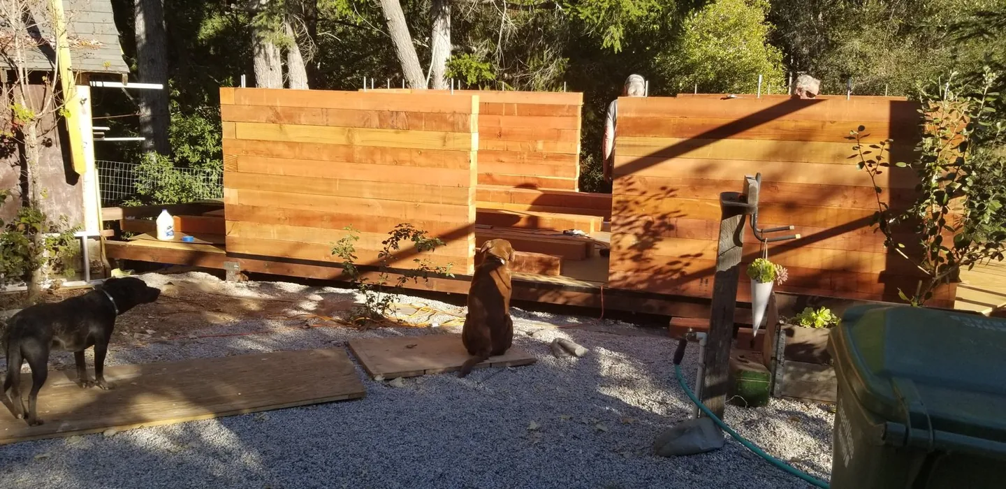 Prototype walls rising from stacked redwood beams