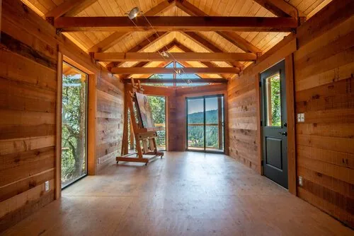 Interior of the prototype studio with exposed redwood walls and trusses